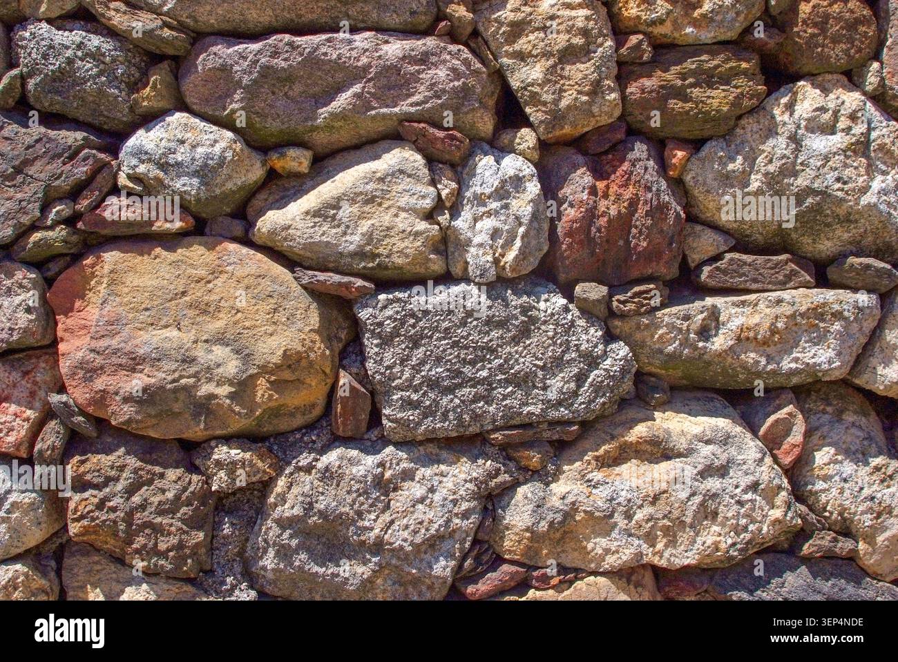Dry-stone wall, rural architecture, granite masonry in Alentejo, Portugal, authentic countryside heritage texture. Stock Photo