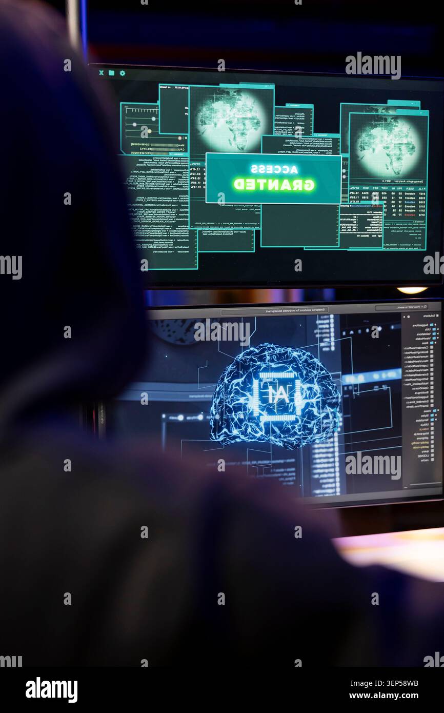 Cybercriminal coding on PC getting access granted message, evading security with stealth malware while evil man successfully making script hiding malicious code from detection systems. Stock Photo