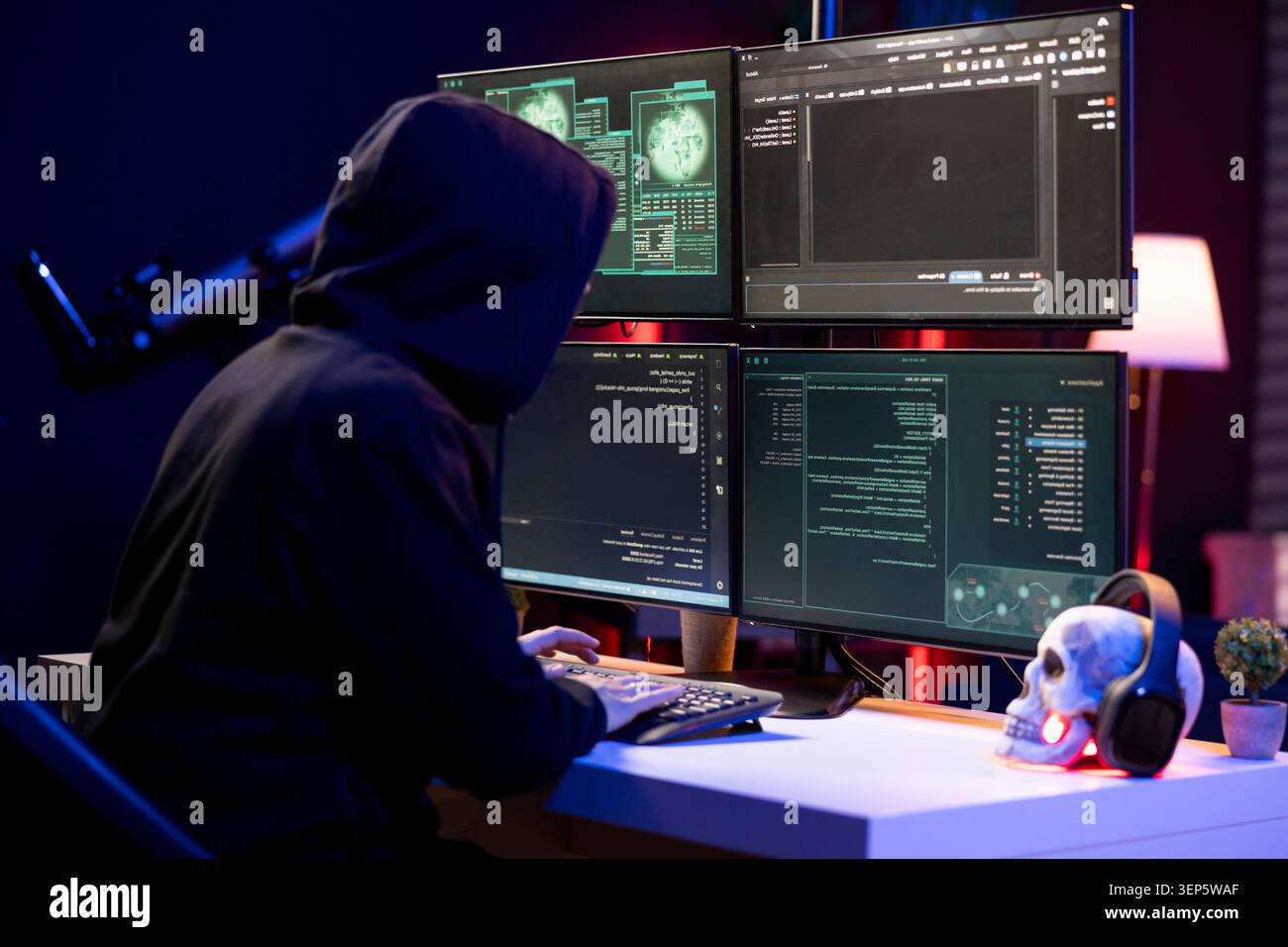 Hacker typing on PC keyboard, using malicious spyware program in a cybersecurity concept. Stock Photo
