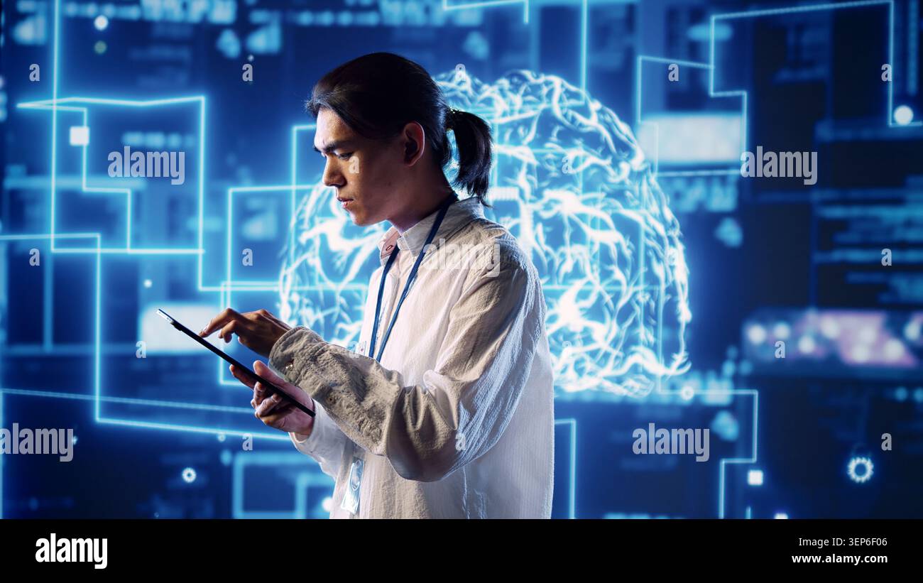 Hardworking system administrator in data center uses artificial intelligence computing simulating human brain thought processes, server room manager works on tablet with AI machine learning. Stock Photo