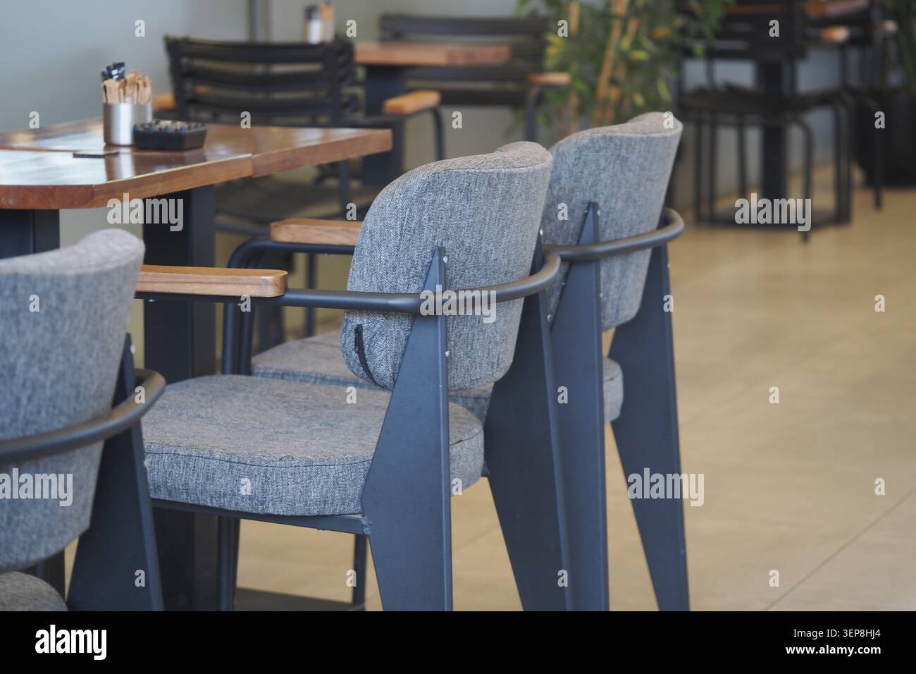 Empty chairs in a cafe during midday hours Stock Photo