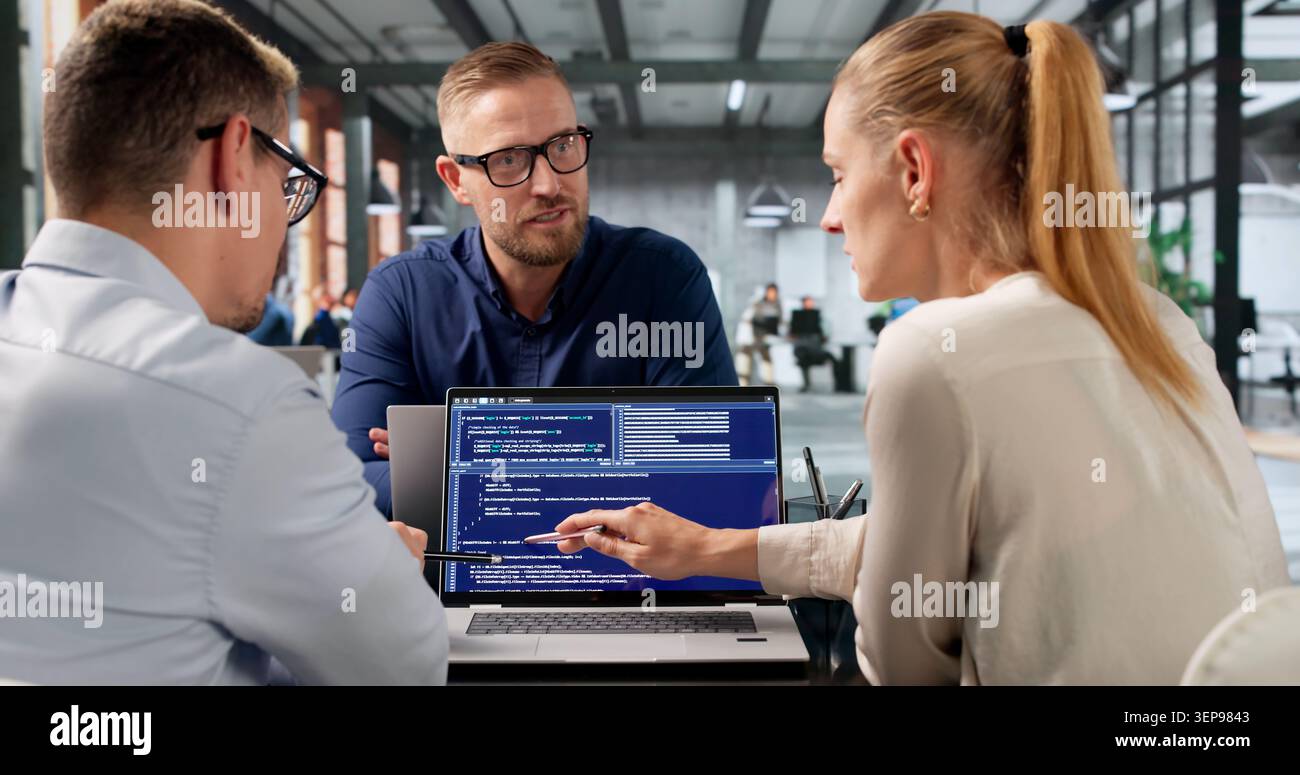 Diverse Group Of Software Engineers Works Together Developing Secure Web Applications. Stock Photo