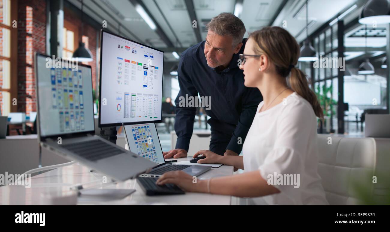 Two Designers Work Together On App Interface During Online Webinar Session. Stock Photo