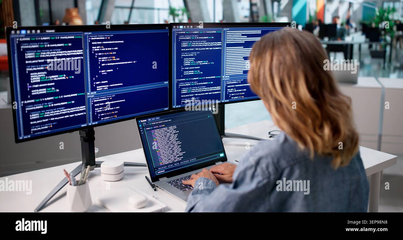 Woman Developer Writes Code On Laptop Using Cloud-based Programming Tools. Stock Photo