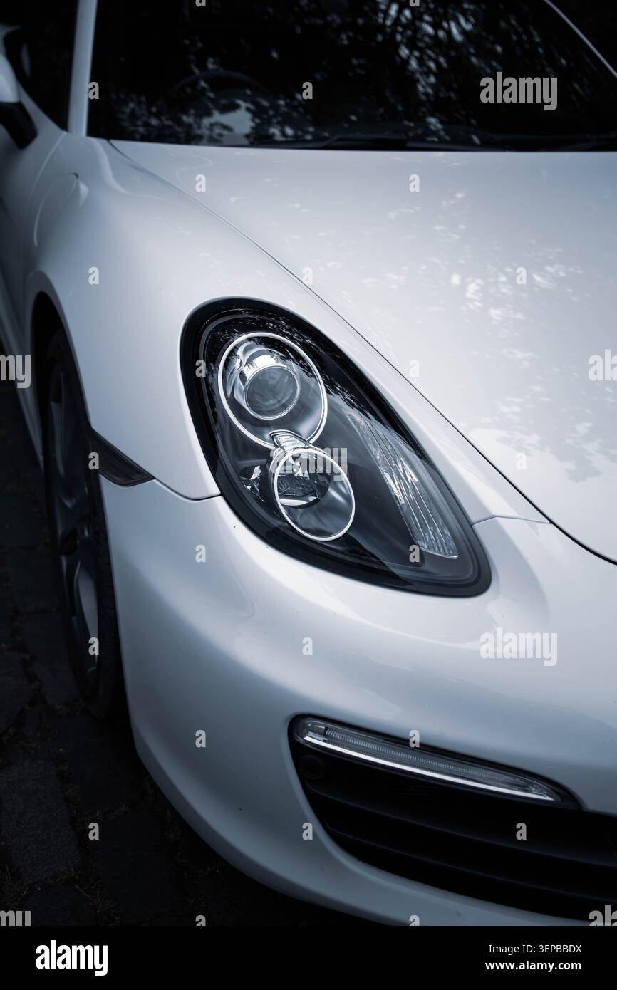 White Porsche Cayman Headlight Close-up Stock Photo