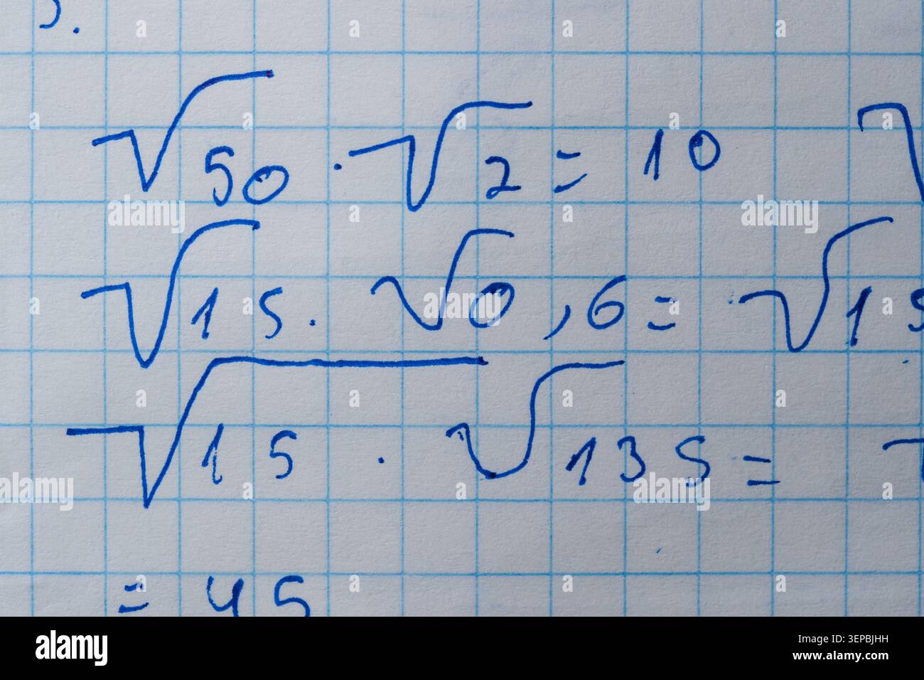 Notes filled with square roots and equations fill a grid paper, showcasing learning. Stock Photo
