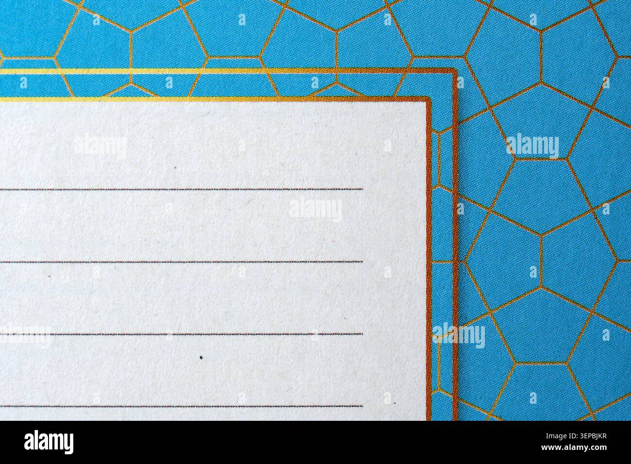 Bright blue backdrop featuring hexagonal shapes and a blank note area invites creativity. Stock Photo