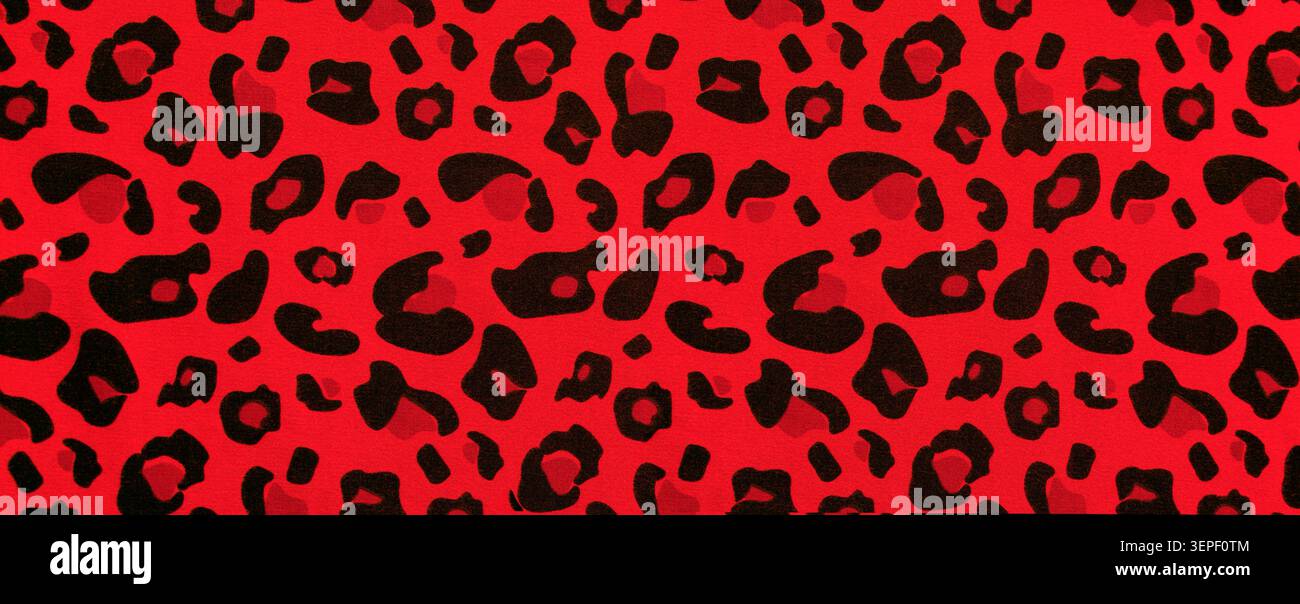 Red leopard print creating a vibrant animal pattern on fabric Stock Photo