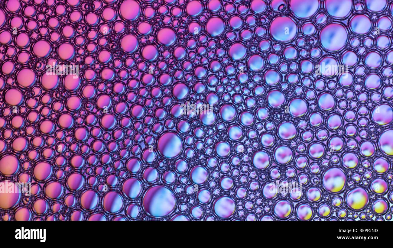 Abstract background showing colorful gradient soap bubbles on a liquid surface Stock Photo