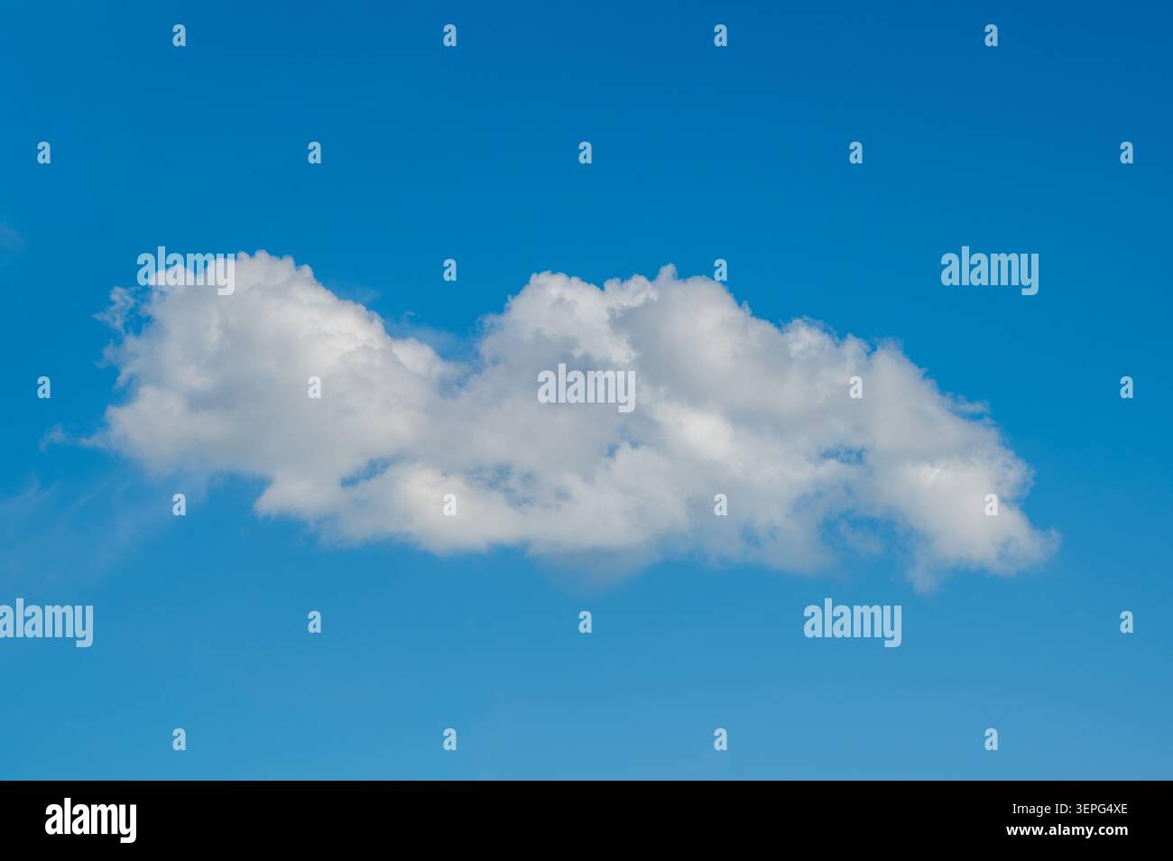 Single White Cloud Floating In Clear Blue Sky Stock Photo