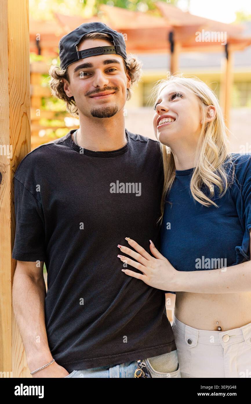 Happy young couple standing outdoors Stock Photo