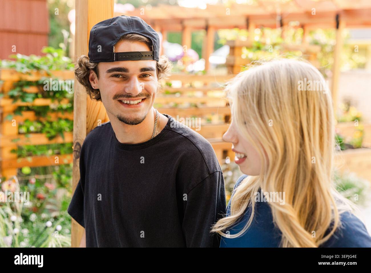 Happy friends talking outdoors in summer Stock Photo