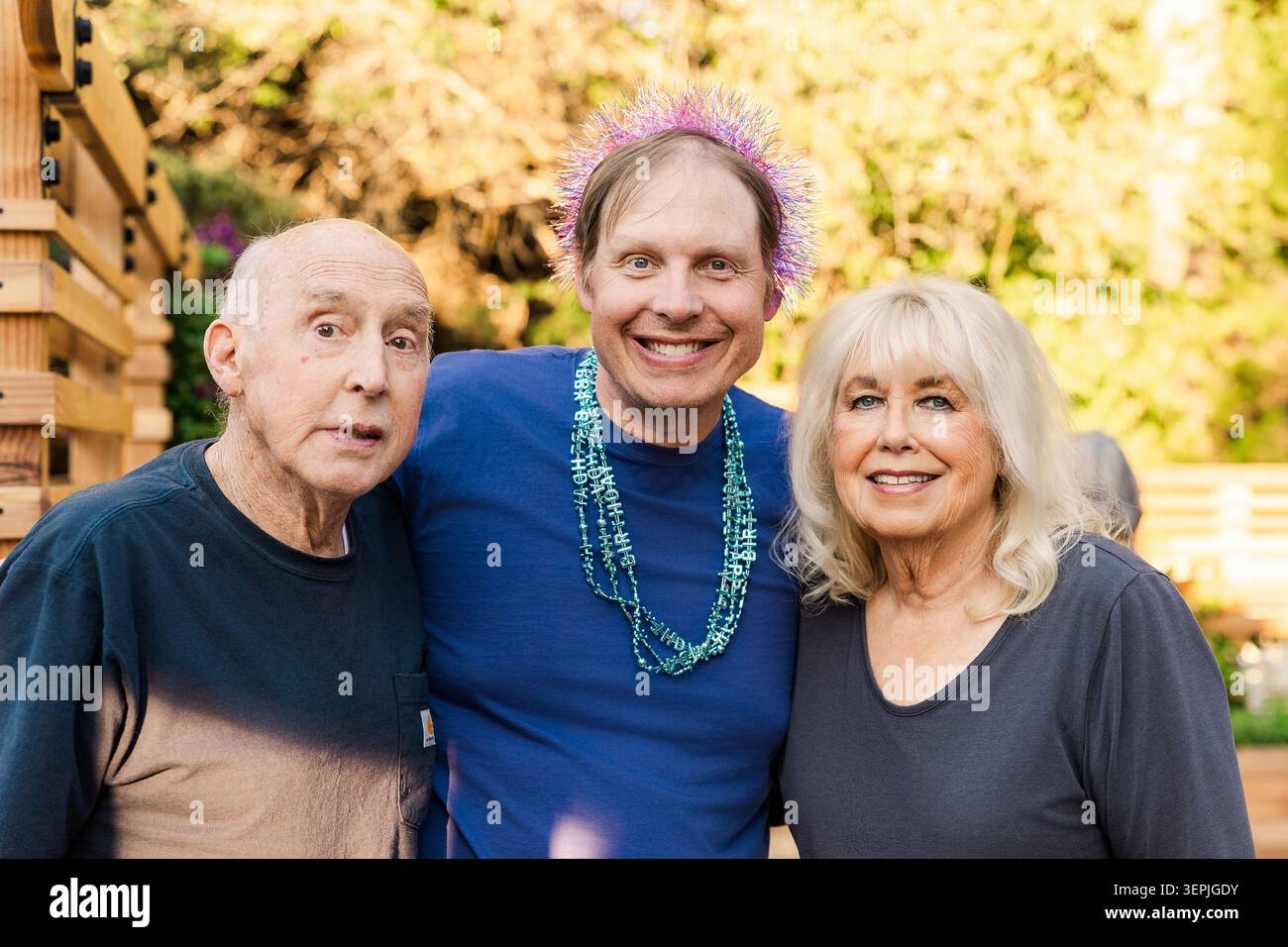 Happy middle aged man with older parents Stock Photo