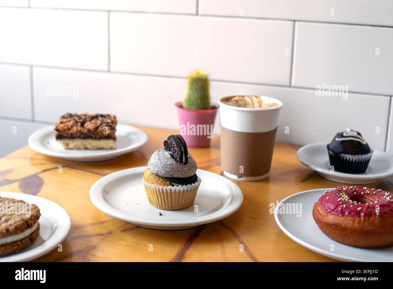 Assorted pastries and coffee on a cafe table Stock Photo