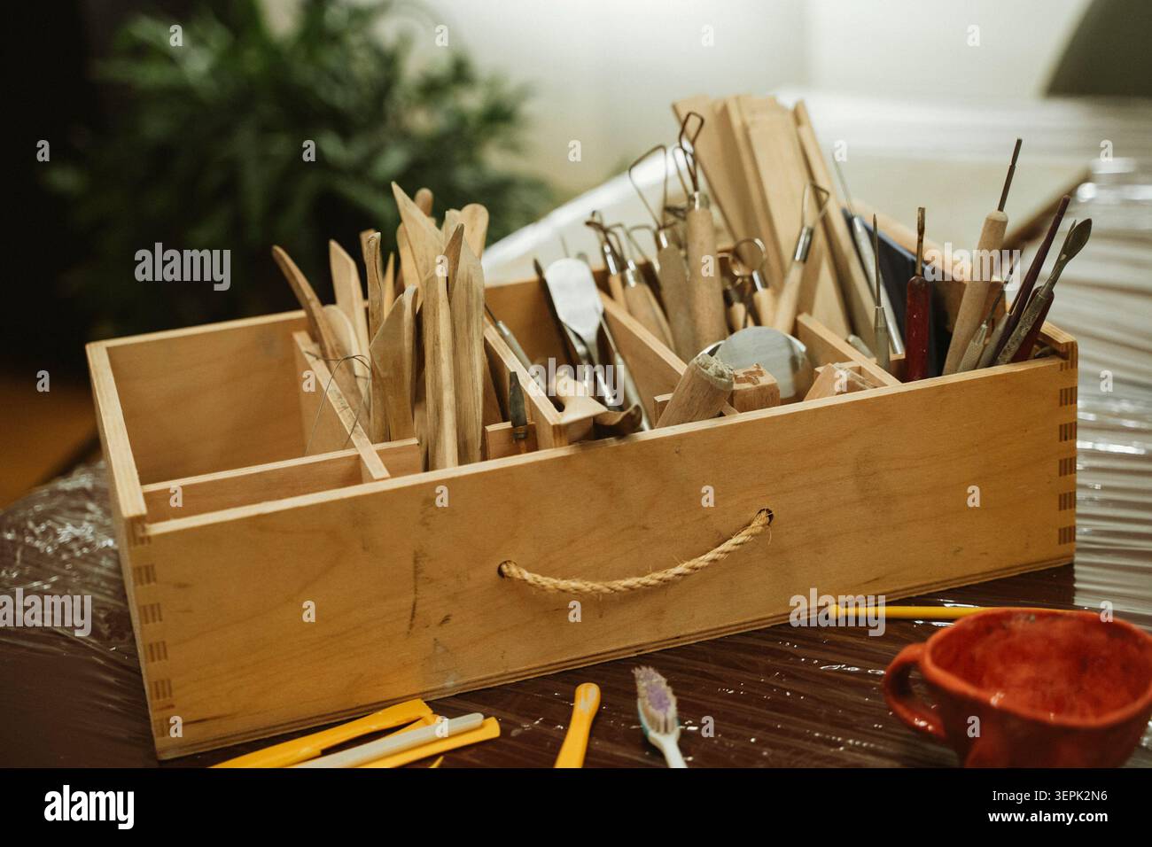 Ceramic Tool Set in Wooden Box on Studio Table Stock Photo