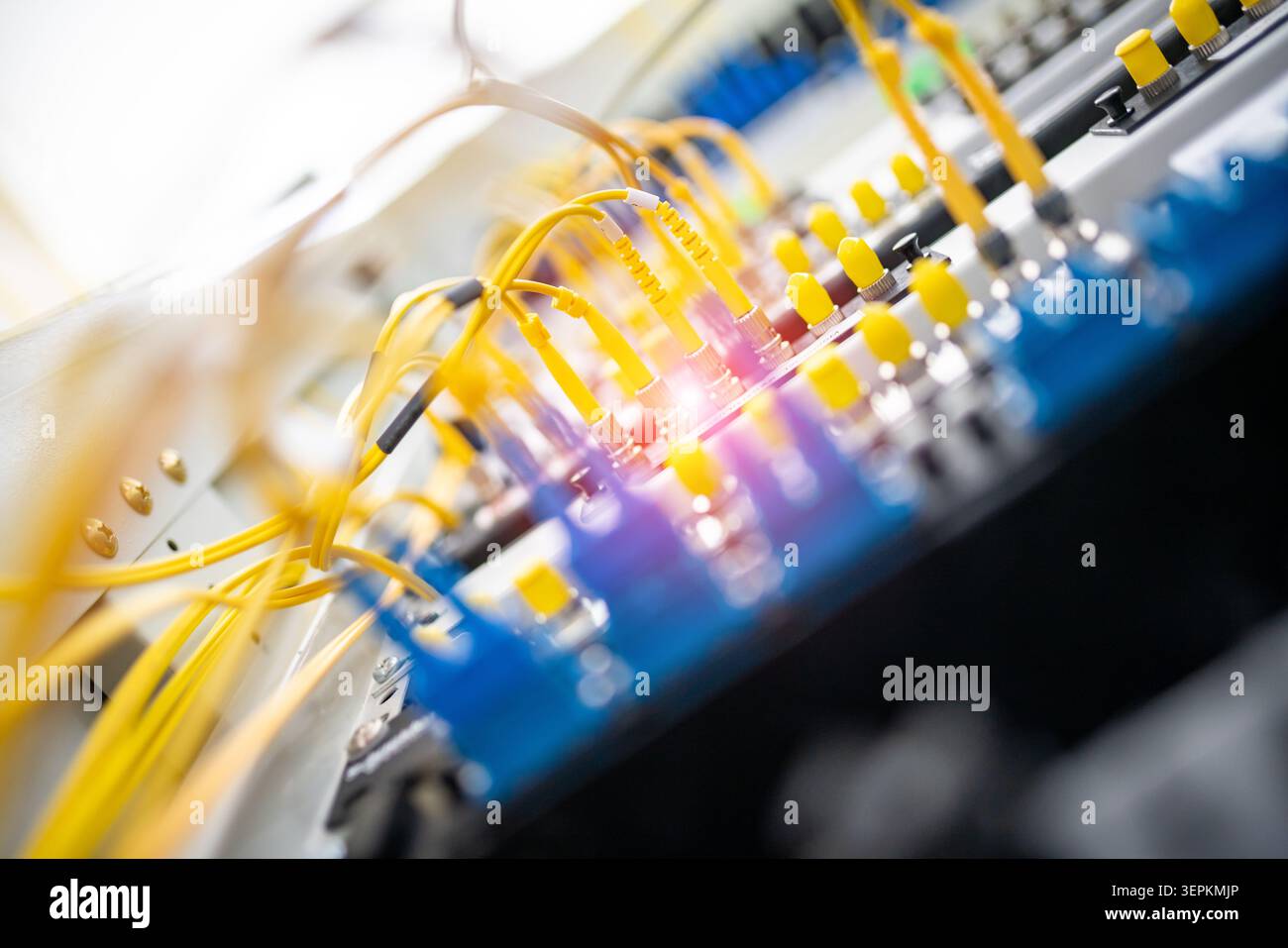 Fiber patch panel with connected optical cables in a server rack data center Stock Photo
