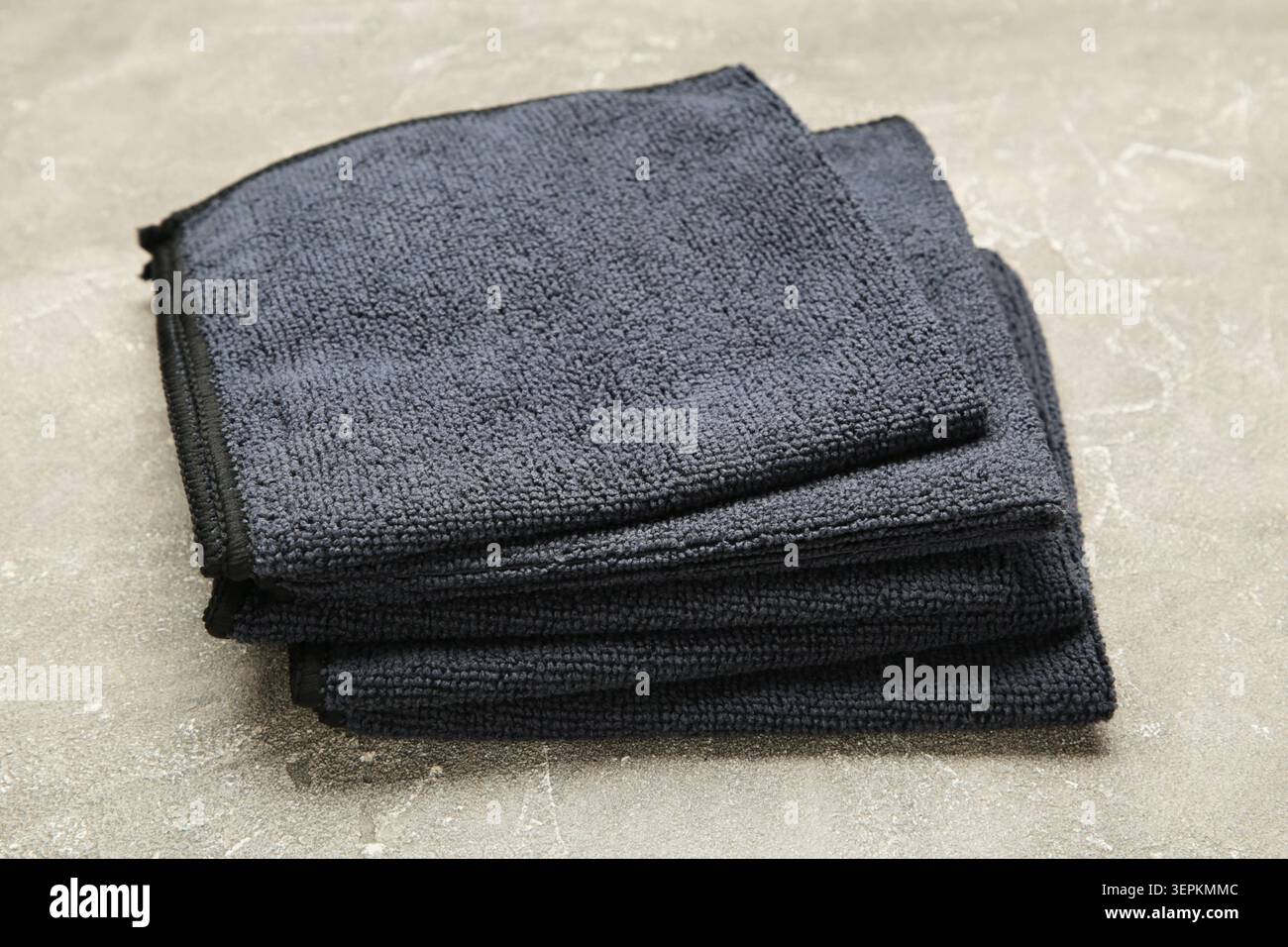 Microfiber cloth for cleaning and dusting on grey concrete background. Top view Stock Photo