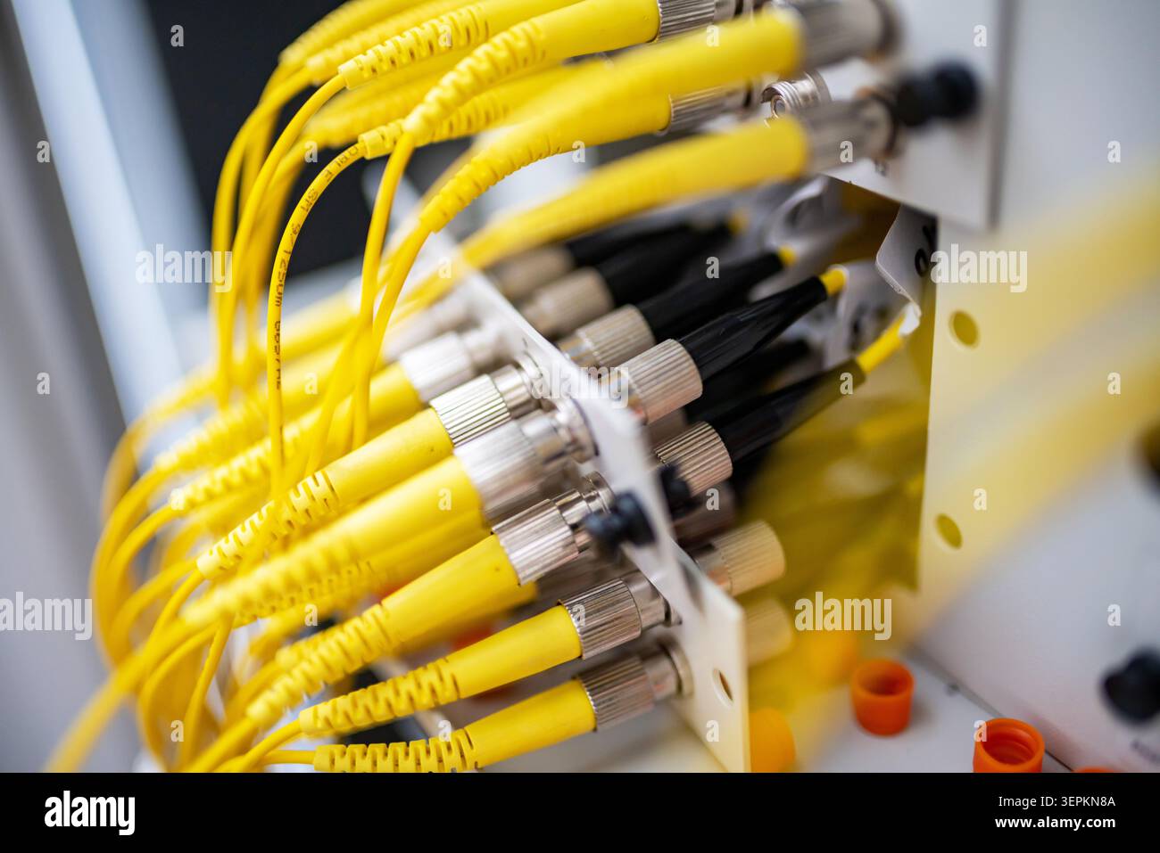Fiber patch panel with connected optical cables in a server rack data center Stock Photo