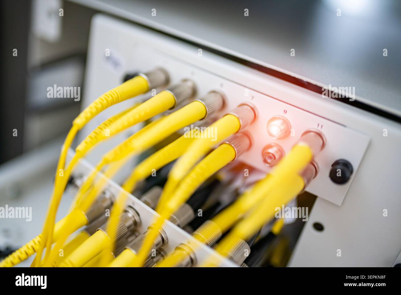 Fiber patch panel with connected optical cables in a server rack data center Stock Photo