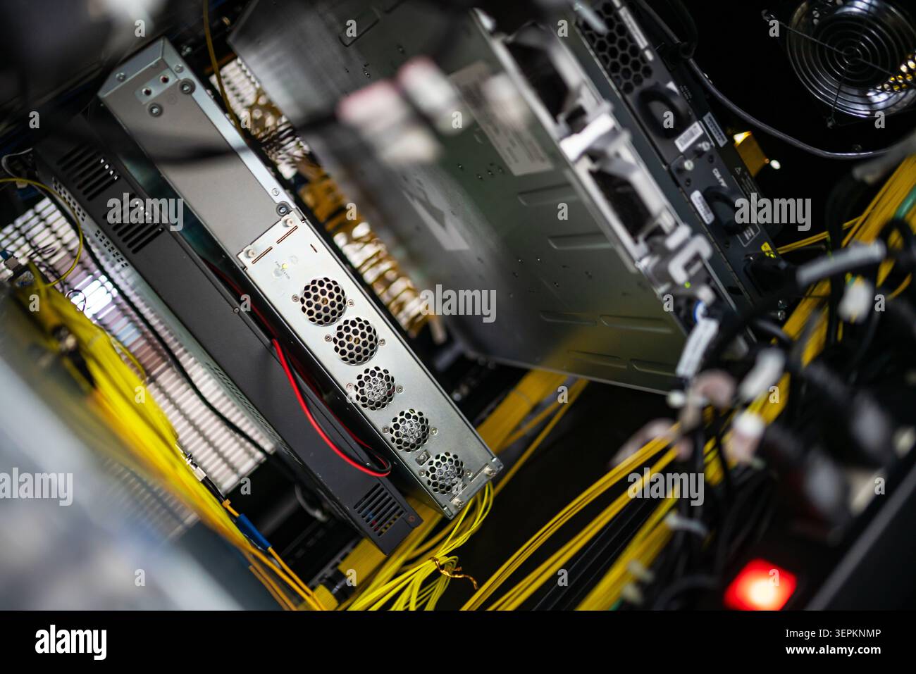 This image shows the inside of a server data center room with multiple servers, interconnected network cables, and cooling systems, emphasizing techno Stock Photo