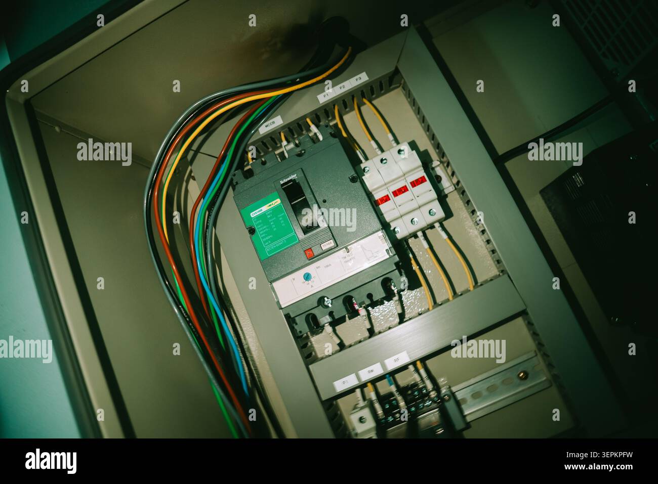 This image features an open electrical circuit breaker panel showcasing various wiring, switches, and safety components essential for electrical distr Stock Photo