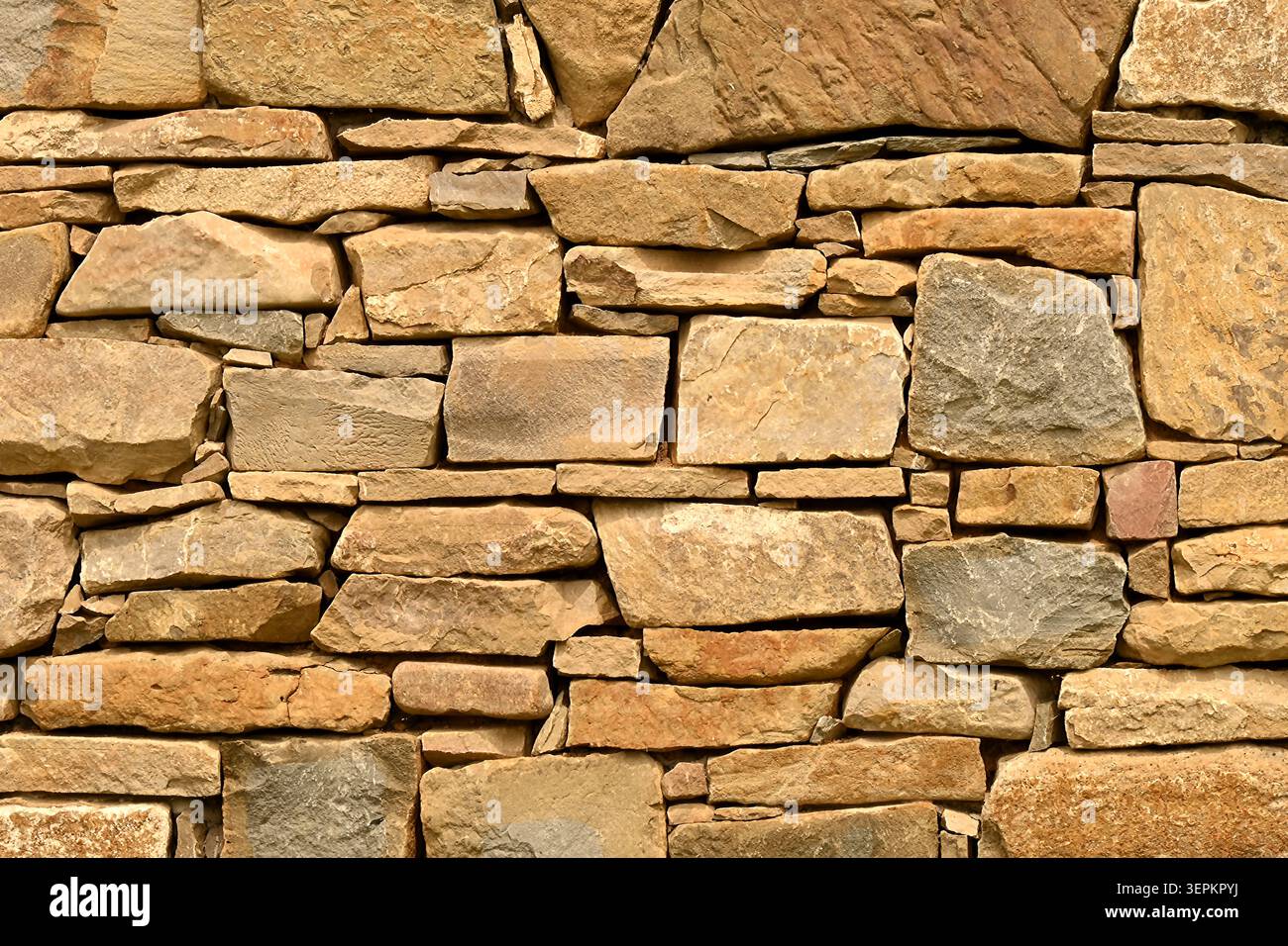 Rustic stacked stone wall background Stock Photo