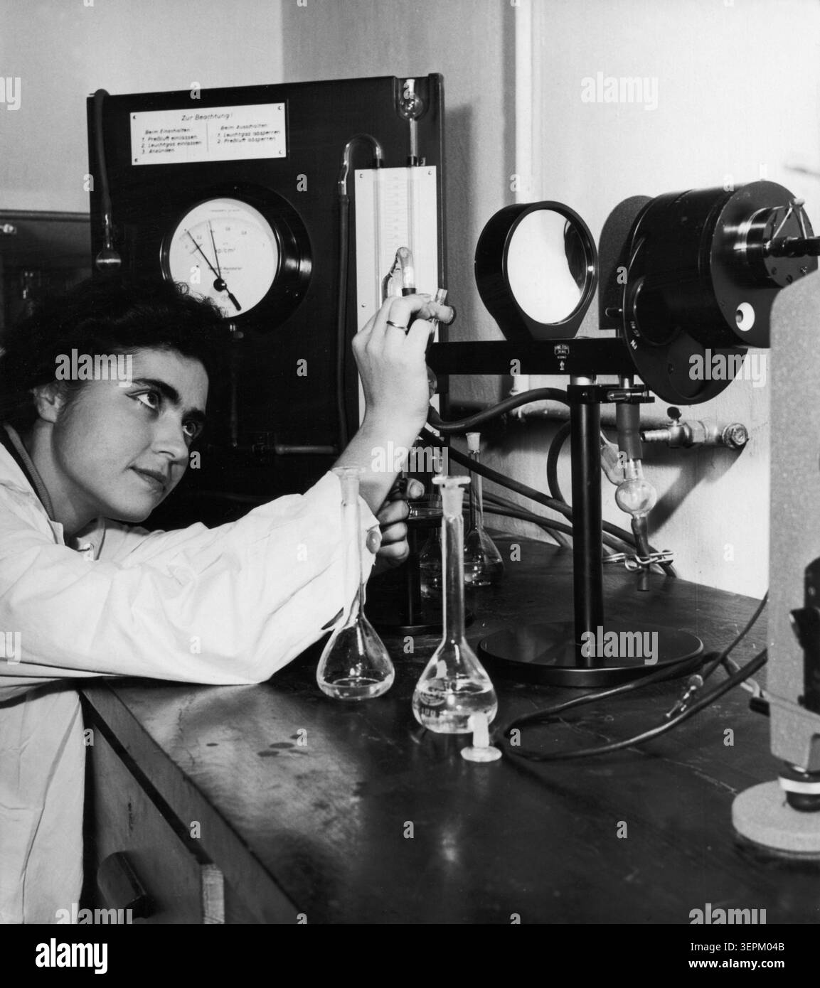 A young woman performing an experiment at the peat science laboratory at the higher school of rural economy in warsaw, poland may 1964, there are now more than three times more academic schools than before the war, the number of scientific research workers increased five-fold while the number of first year students in the academic year 1963/64 is far greater than the total number of students in all years of studies in all polish academic schools in the last pre-war year. Stock Photo