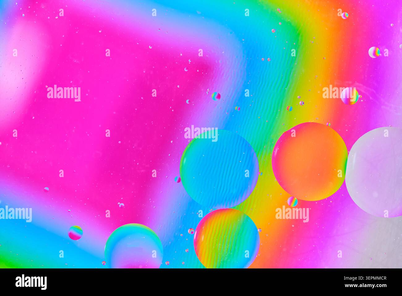 Macro photograph large oil spheres with rainbow gradient reflections on bright background Stock Photo