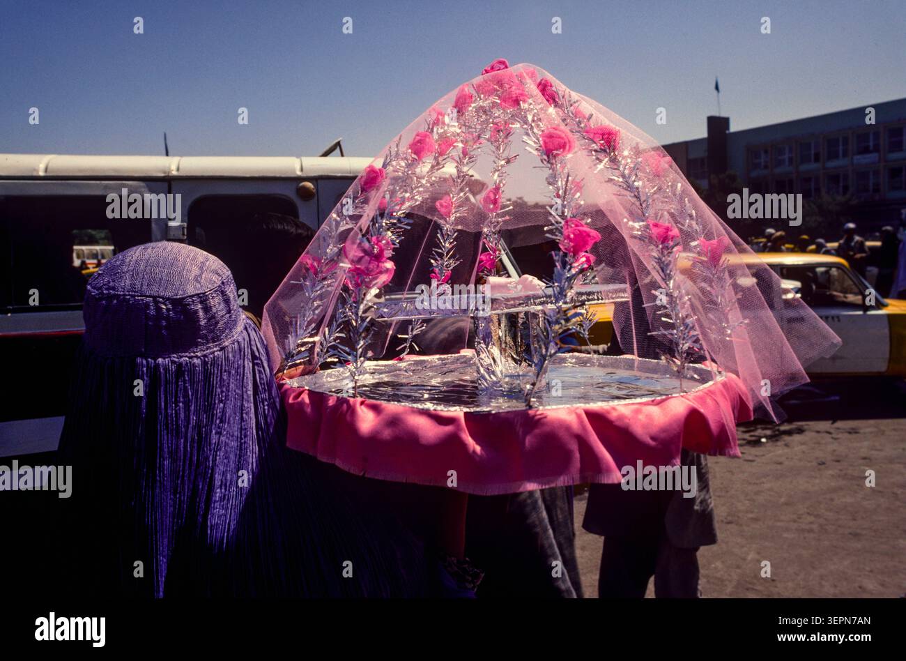 A woman delivering an iced drink, Kabul, Afghanistan, 1992 Stock Photo