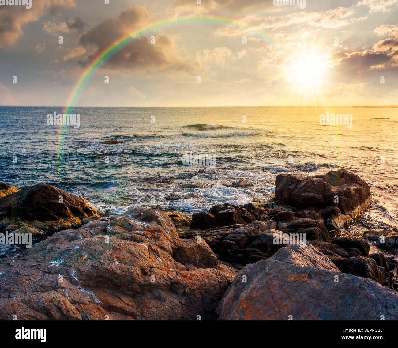 sunset over sea coast with stones and rocks. summer vacation background. seascape with rough terrain. relaxing at the sea. coast of bulgaria. weather Stock Photo