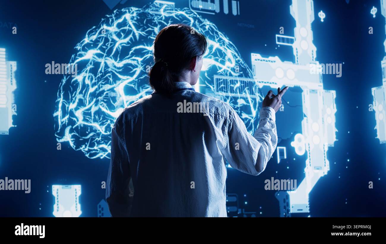 Experienced admin looking at hologram of artificial intelligence cognitive computing human brain simulation. Certified engineer interacting with AR AI visualization showing machine learning algorithms Stock Photo