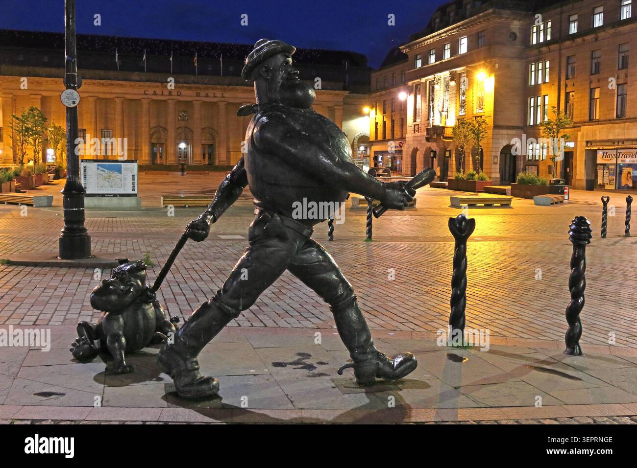 Desperate Dan and Dawg bronze statues outside Caird Hall in Dundee city centre at dusk, celebrating DC Thomson Dandy & Beano comic heritage Stock Photo