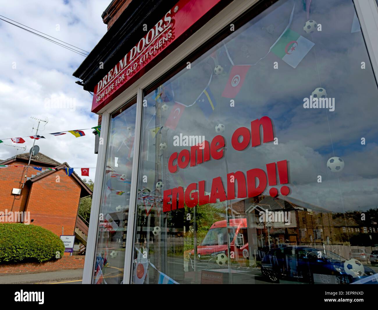 World Cup 2026 support at Dream Doors in Grappenhall, Warrington, with a Come On England window display and football decorations Stock Photo