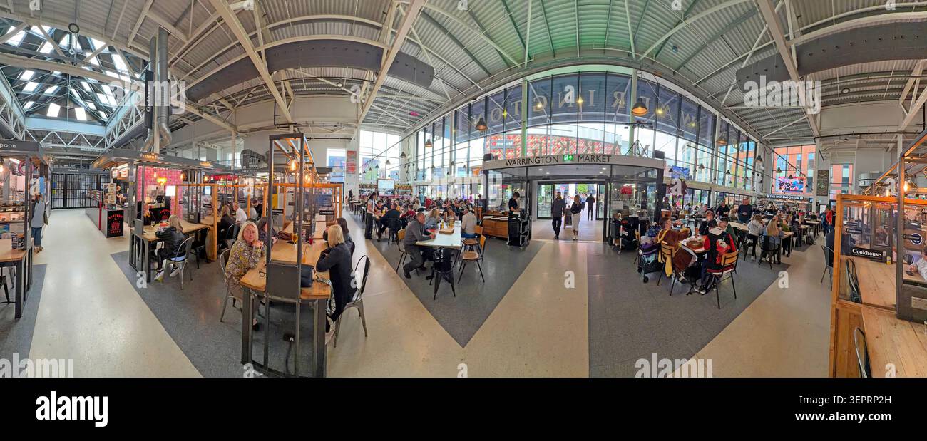 Busy regenerated Warrington Market food hall on a Saturday afternoon, with customers eating and drinking beneath its modern vaulted roof Stock Photo