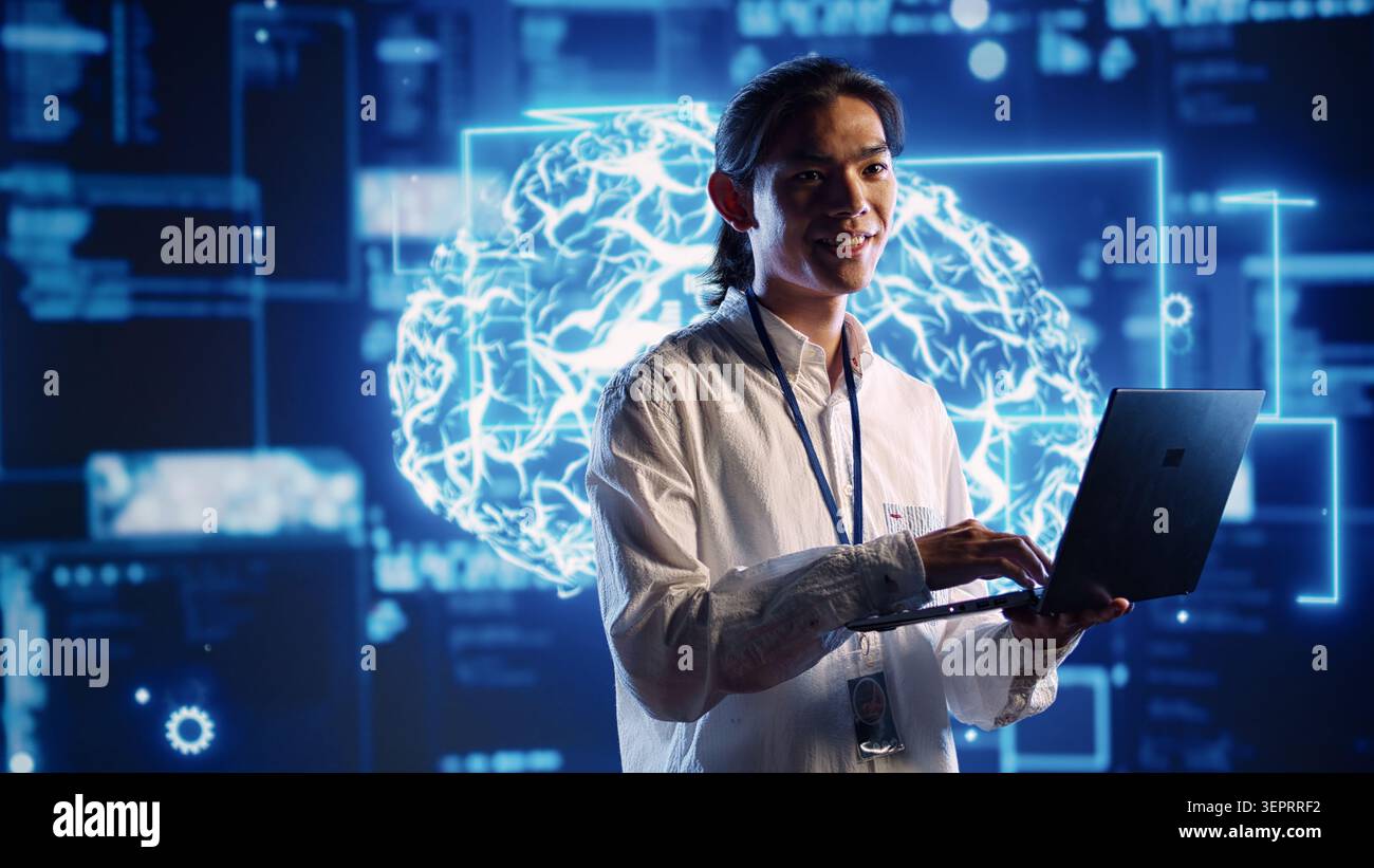 Asian admin in data center using artificial intelligence computing simulating human brain thought processes in computerized model. Employee holding laptop, working with AI machine learning algorithms Stock Photo