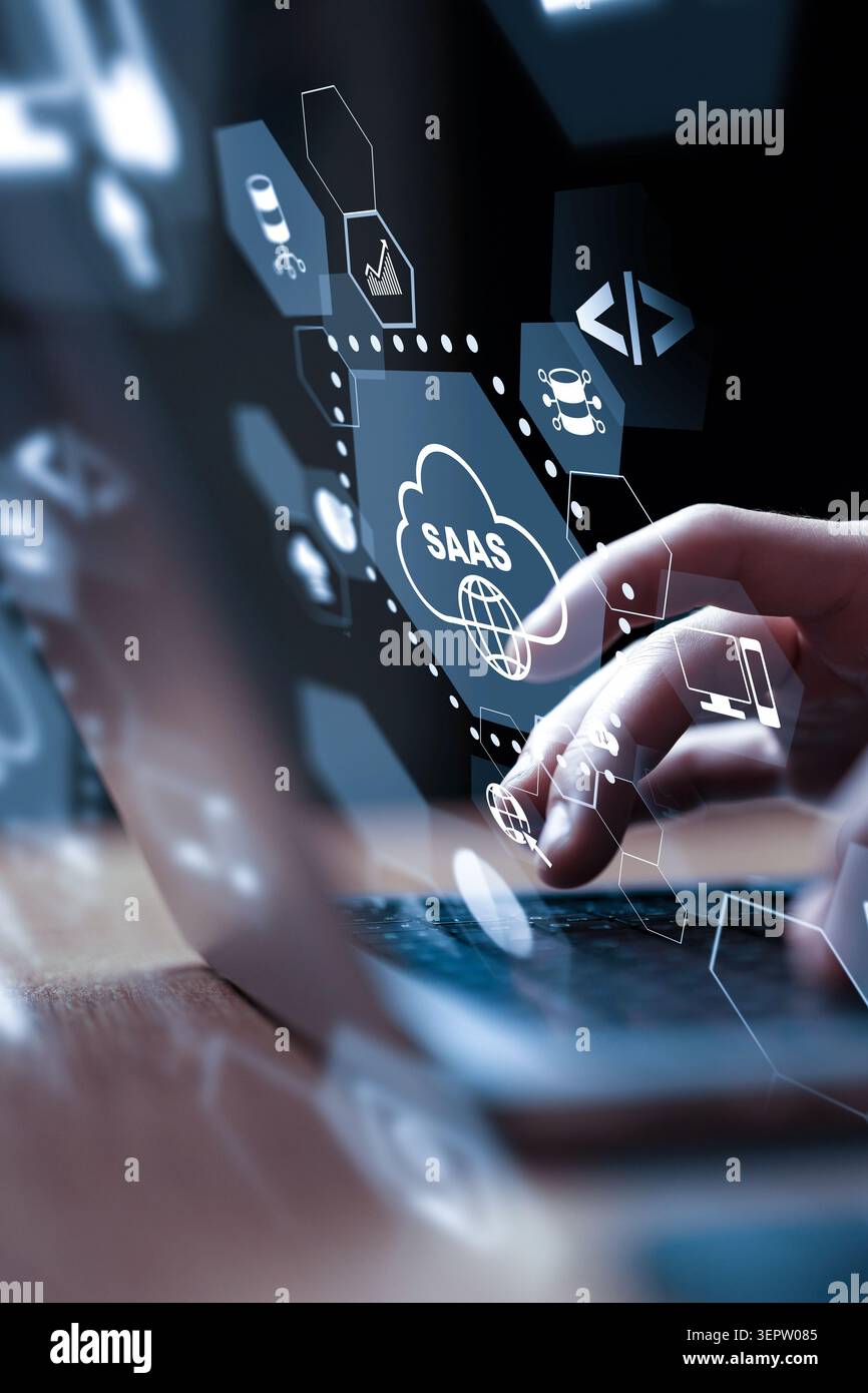 Using a laptop to access SaaS technology and tools for business solutions Stock Photo
