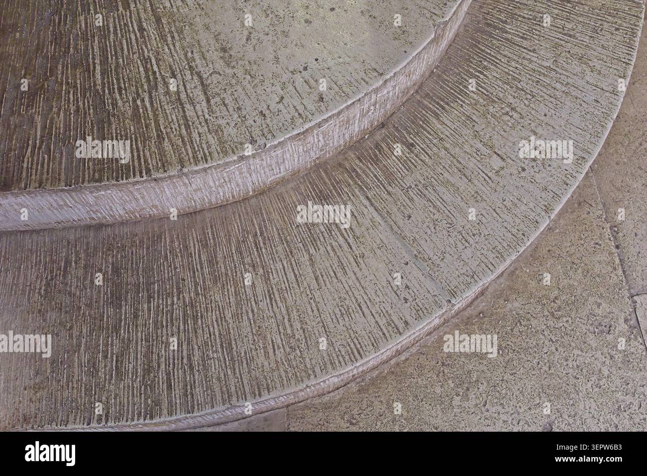 Curved concrete stairs featuring a prominent broom-finish or raked slip-resistant texture, Estonia, Europe. Stock Photo
