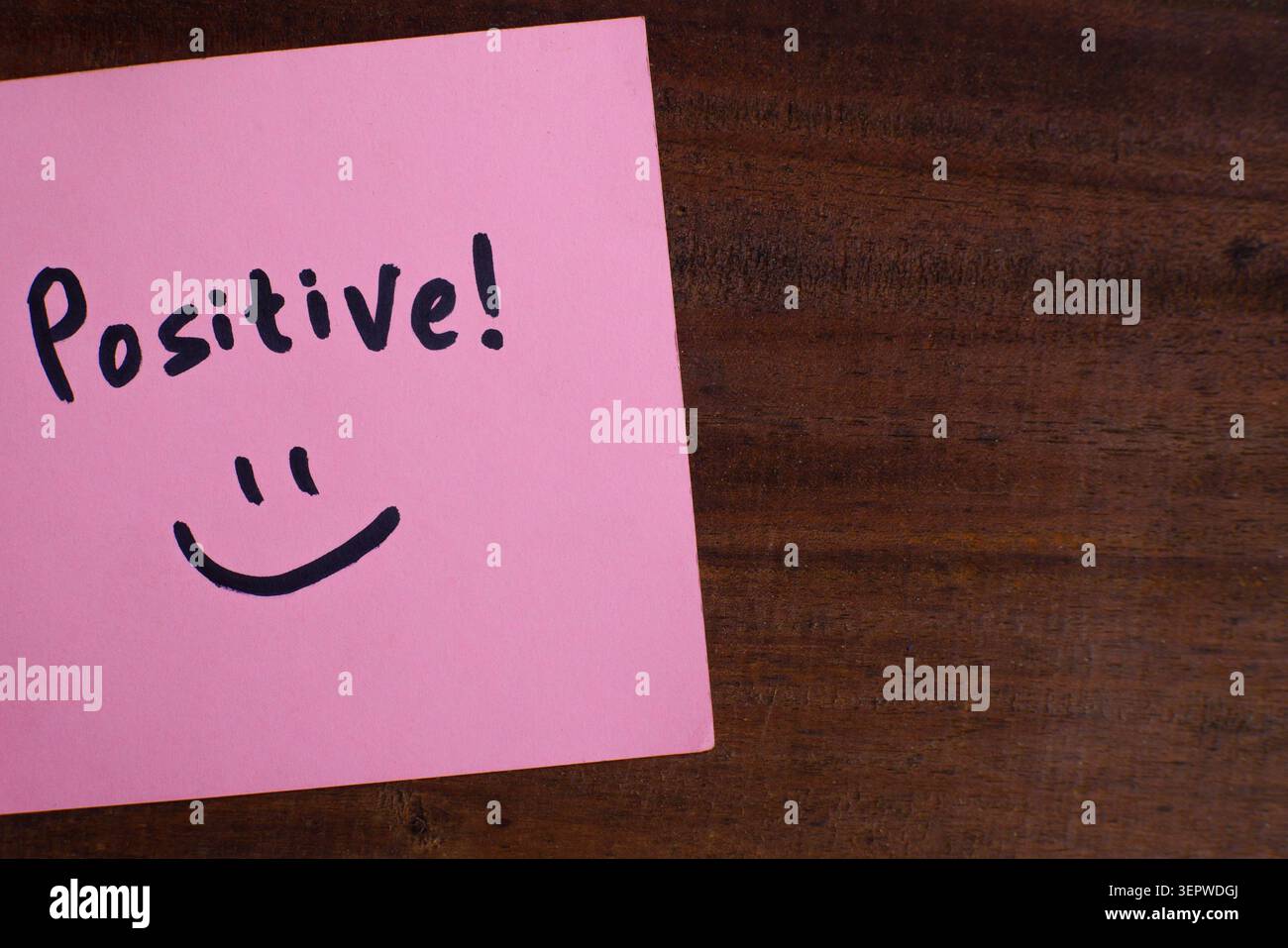 Positive Message Sticky Note on Wooden Background Stock Photo