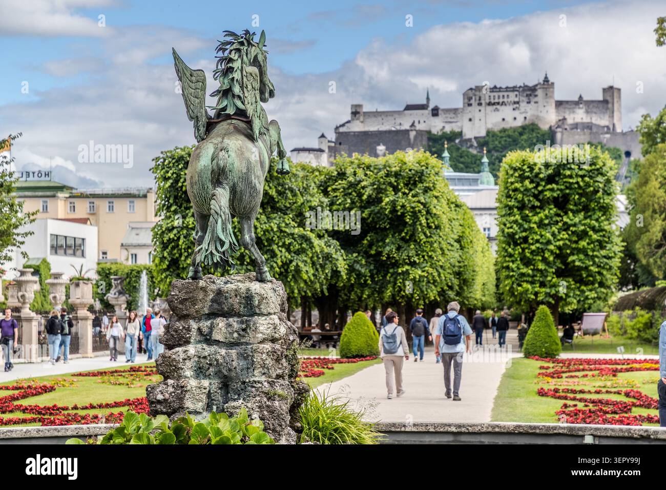 The bronze statue of Pegasus in the Mirabell Gardens looks out over passers-by and Hohensalzburg Fortress. The Baroque Mirabell Gardens form part of the UNESCO World Heritage Site ‘Historic City Centre of Salzburg’. Salzburg, Austria Stock Photo