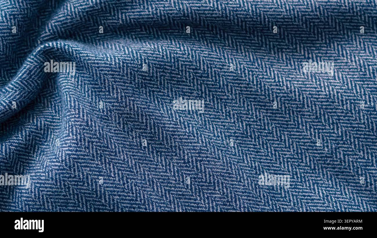 Blue crumpled herringbone fabric texture close up. Stock Photo