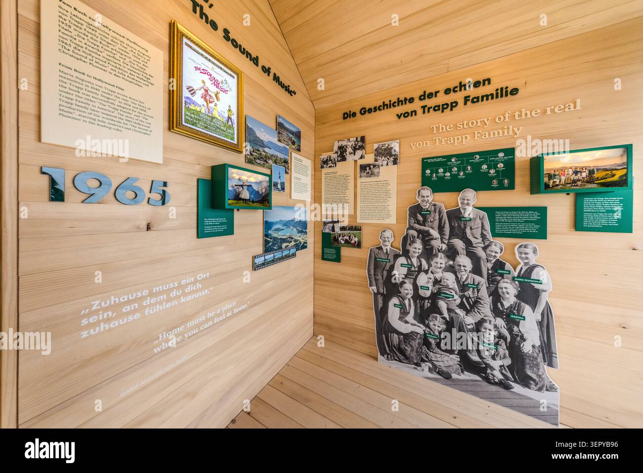 Exhibition display in the Von Trapp Pavilion on the Zwölferhorn near St. Gilgen: The panel entitled ‘The Story of the Real von Trapp Family’ features the film poster for *The Sound of Music* (1965) as well as a family photograph of the historical Trapp family. A quote carved into the wood reads: “Home must be a place where you can feel at home.” The von Trapp family were the real-life inspiration for the Rodgers and Hammerstein musical. St Gilgen, Salzburg, Austria Stock Photo