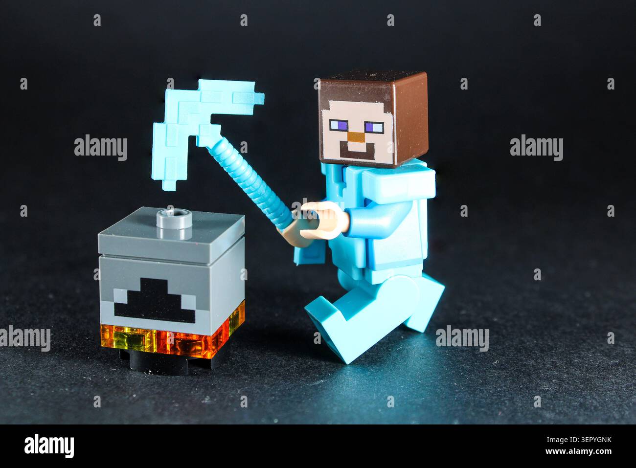 Lego Minecraft Character, trying to work on a crafting table. Stock Photo