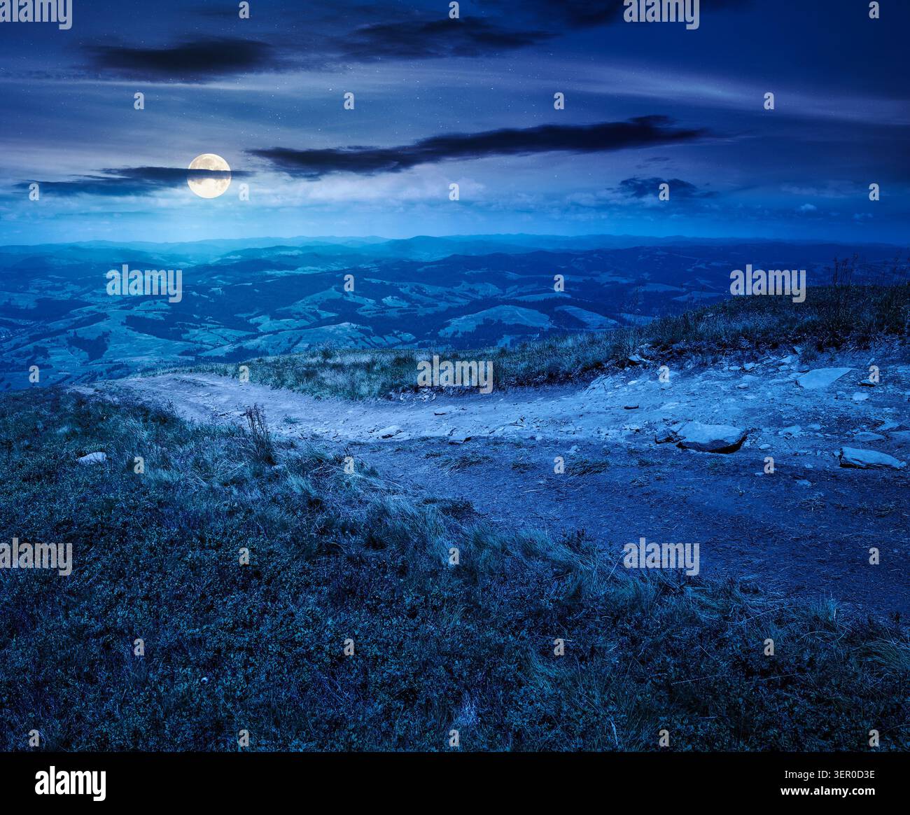 hiking path in carpathian mountains at night. full moon over alpine nature of transcarpathia in summer. ukraine mountain landscape for travel. views o Stock Photo