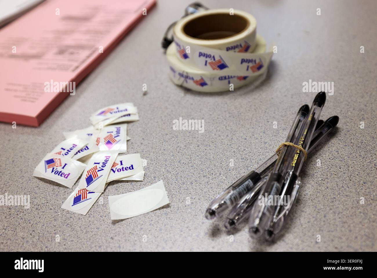 Pens, stickers and ballots are on a table at a polling location inside ...