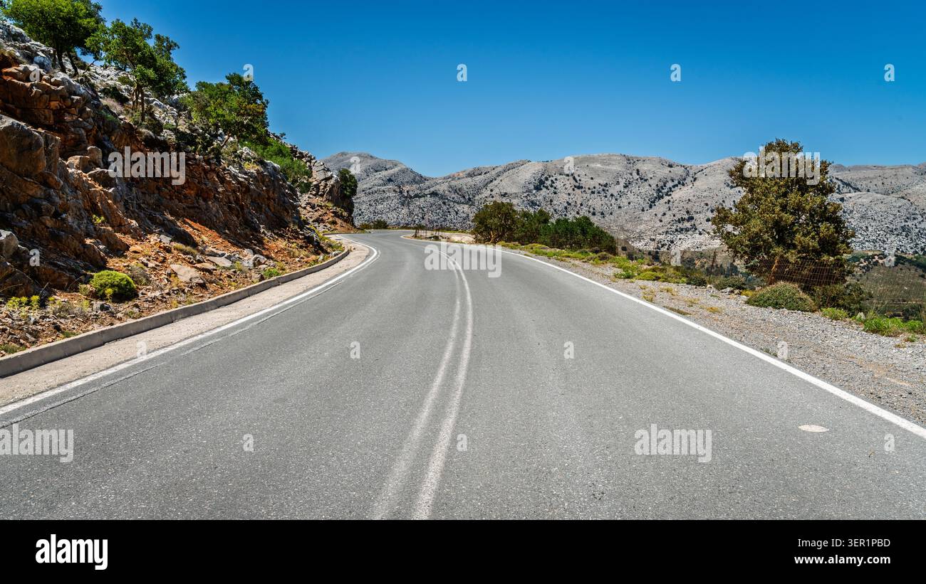Two lane winding road through Dikti Mountains in eastern Crete, Greece Stock Photo