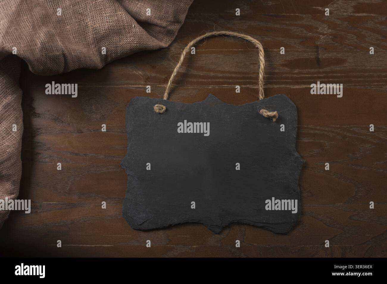 Rectangular black textured slate board for dishes on brown table Stock Photo