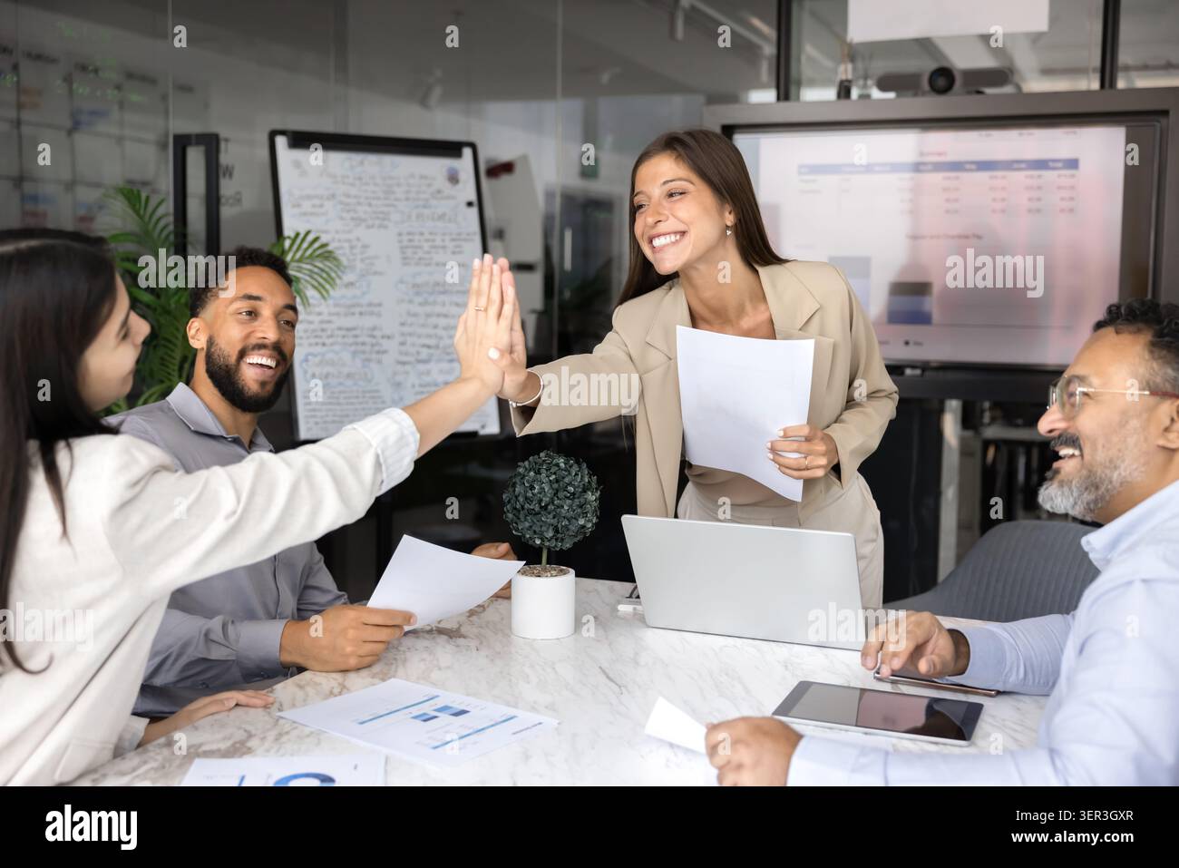 Two happy team members giving high five during training Stock Photo