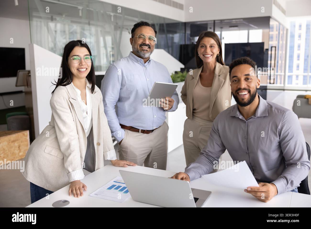 Group of confident four professionals posing together in office Stock Photo