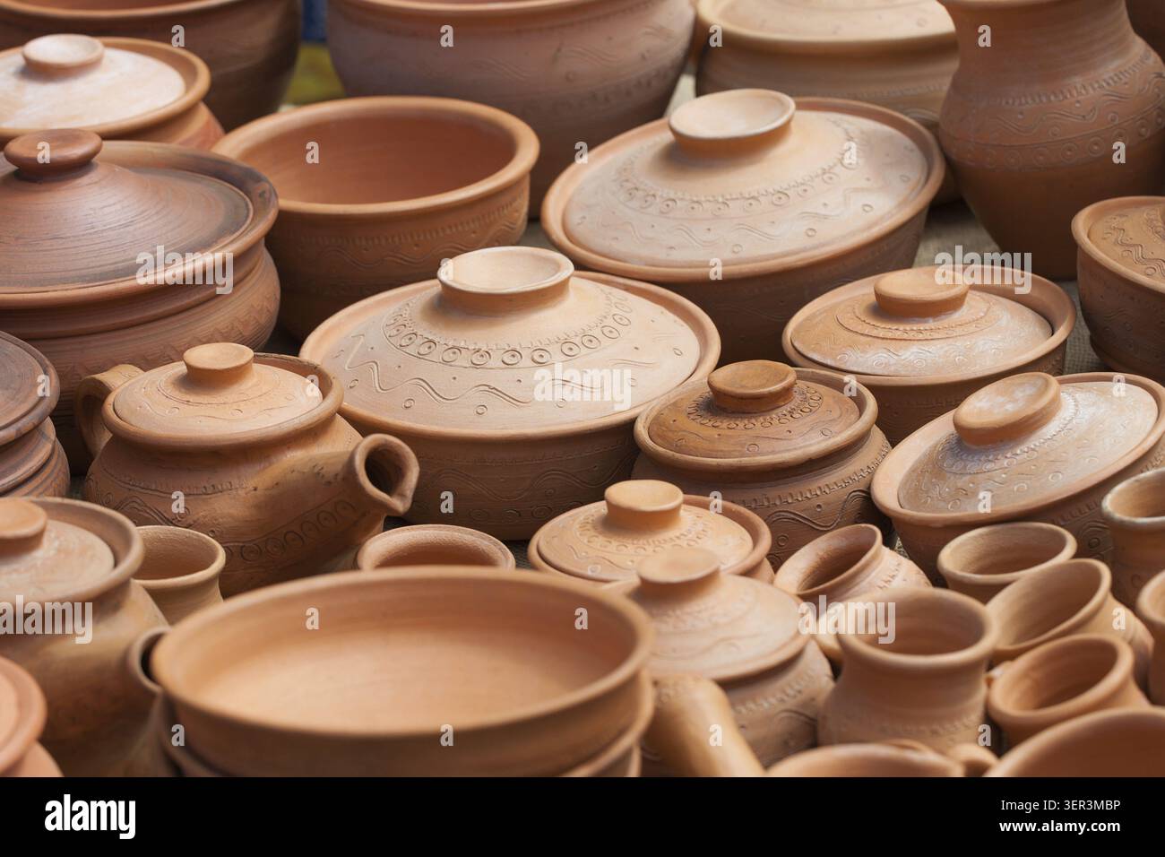 Many earthen pots kept for drying in the sun Stock Photo