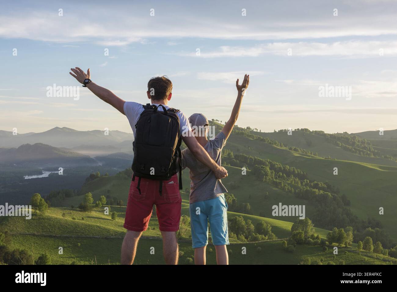 Happy father and son are walking in the Altai mountains Stock Photo